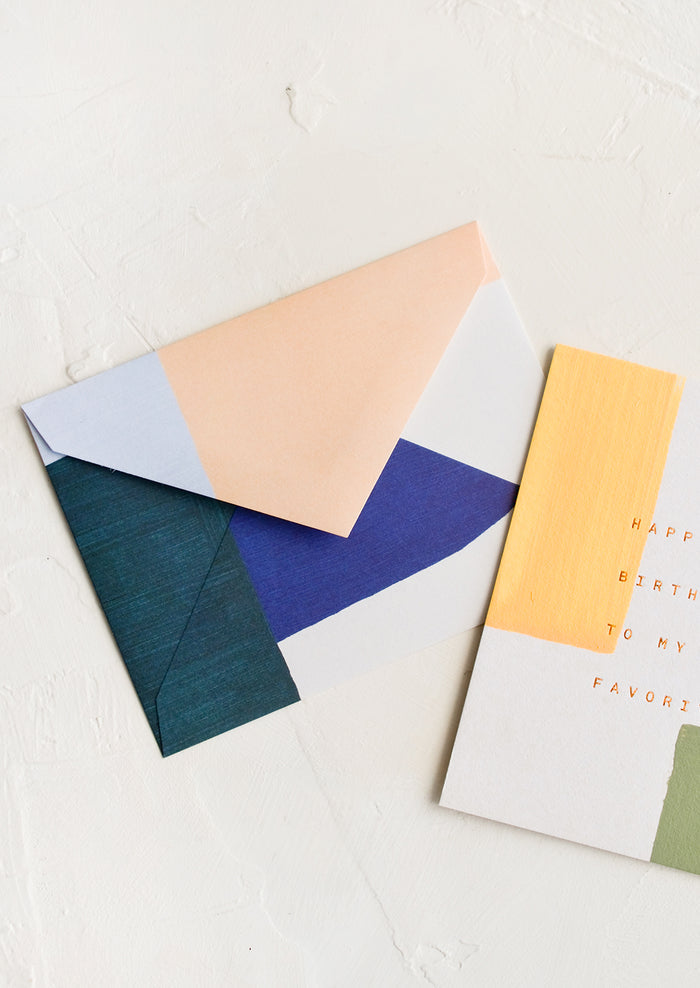 A birthday card with decorative envelope.