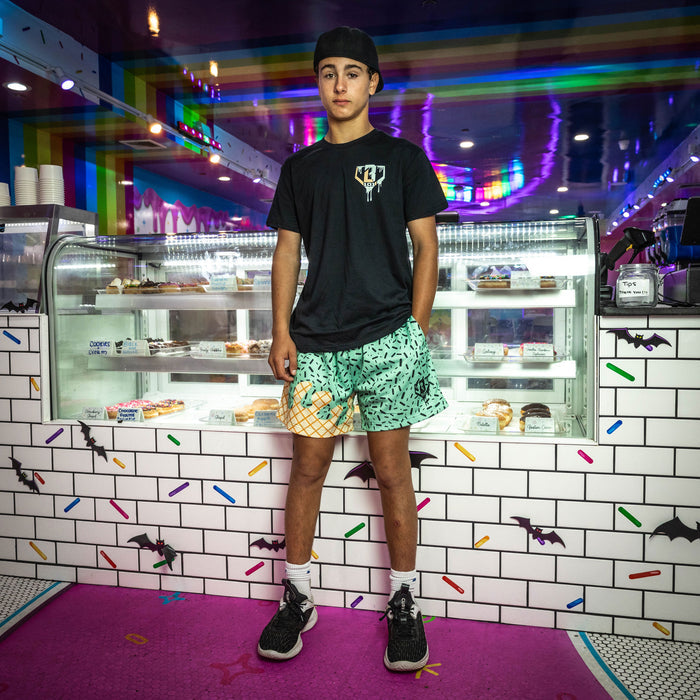 Youth model wearing green Ice Cream Mint youth shorts