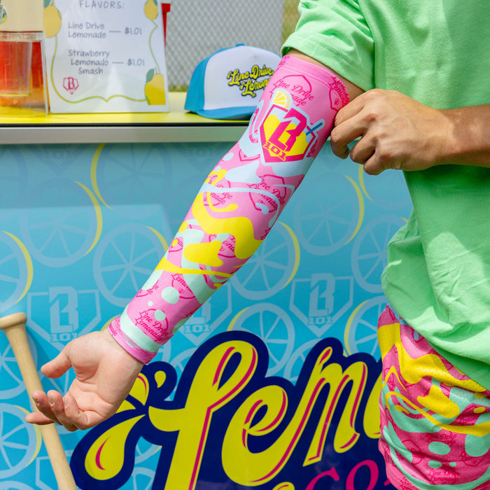 Adult model wearing pink arm sleeve with "Lemon Burst" design