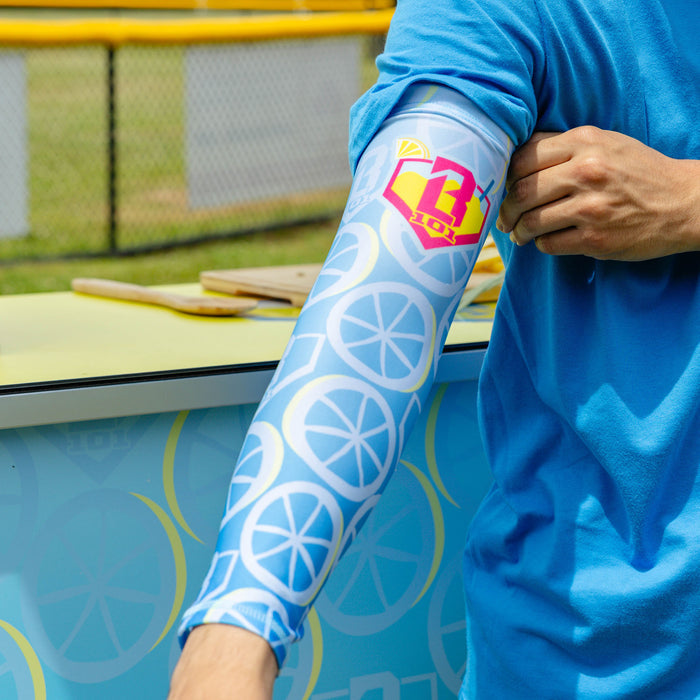 Adult model wearing blue arm sleeve with "Lemonade Splash" design
