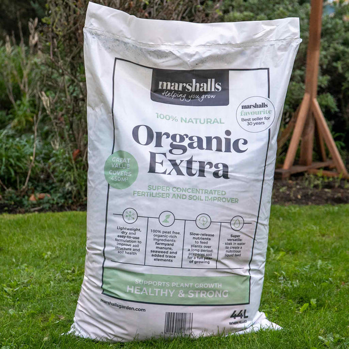 Bag of Marshalls Organic Extra fertiliser on grass.