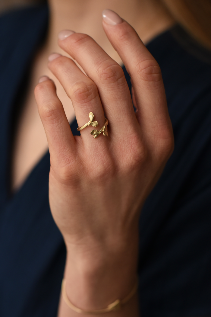 Brass leaf open ring on hand, small sculpted leaf motif on slim band