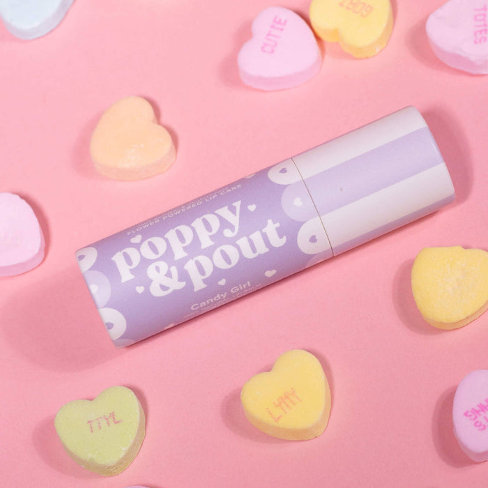 Candy Girl lip balm tube with purple label and heart shapes, angled view