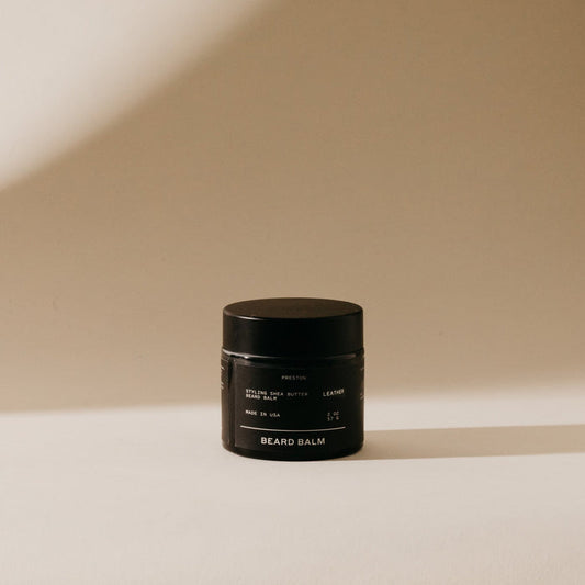 Beard balm jar, black container with gold label and screw-top lid