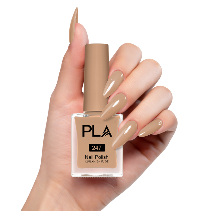 Hand holding a bottle of brown nail polish with 'PLA' branding on a white background