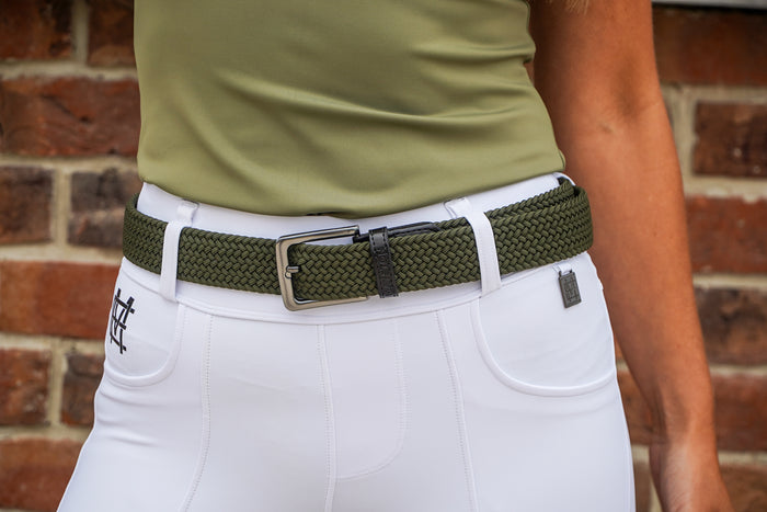 Person wearing a green belt with a brick wall background
Elastic stretch quality belt for casual or riding wear