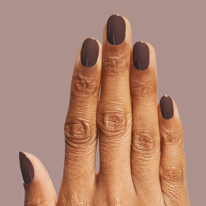 Bunny deep neutral brown quick dry gel polish shown on natural nails against soft mauve background