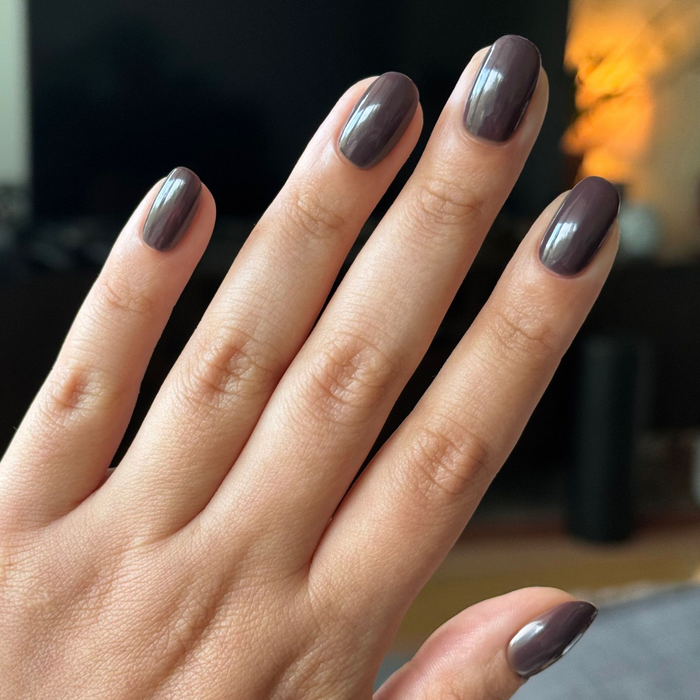 Bunny deep neutral brown gel polish on natural nails with a glossy finish in warm indoor lighting