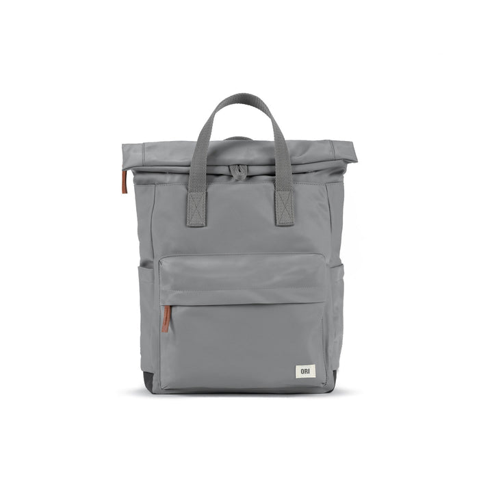 Gray medium nylon backpack with gray top handles, front pocket, and zip closure