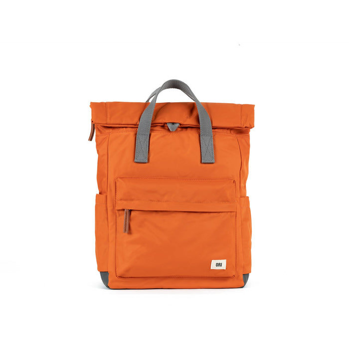 Burnt orange medium nylon backpack with gray top handles, front pocket, and zip closure