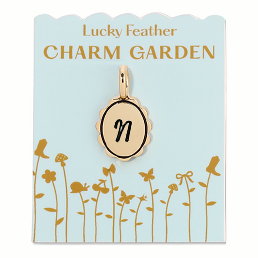 Gold scalloped initial charm with the letter N from Lucky Feather Charm Garden collection, featuring intricate scalloped edges.