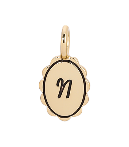 Gold scalloped initial charm with the letter N from Lucky Feather's Charm Garden collection, featuring intricate design details.