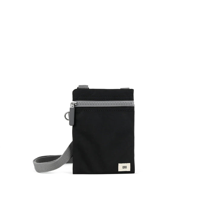 Black recycled nylon pocket crossbody bag with zip top and gray adjustable strap