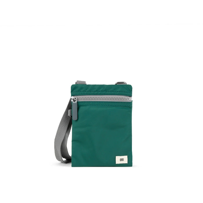 Green recycled nylon pocket crossbody bag with zip top and gray adjustable strap