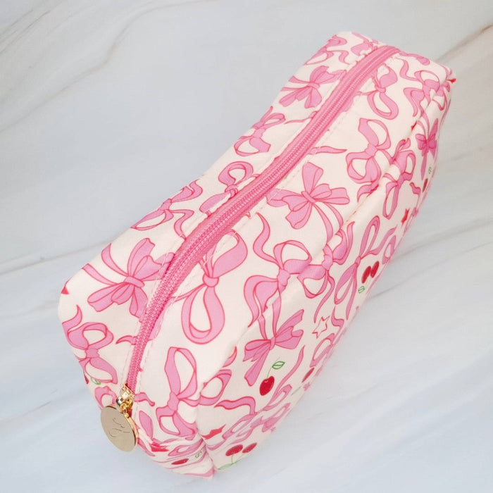 Ellison+Young Cherry Bowtiful everyday cosmetic bag with cherry print, compact design, and zipper closure for makeup and accessories.