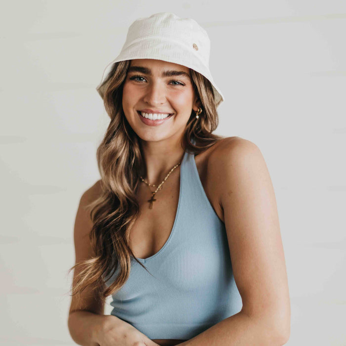 Pretty Simple Clearwater Bucket Hat in beige with wide brim and adjustable chin strap, casual sun protection accessory.