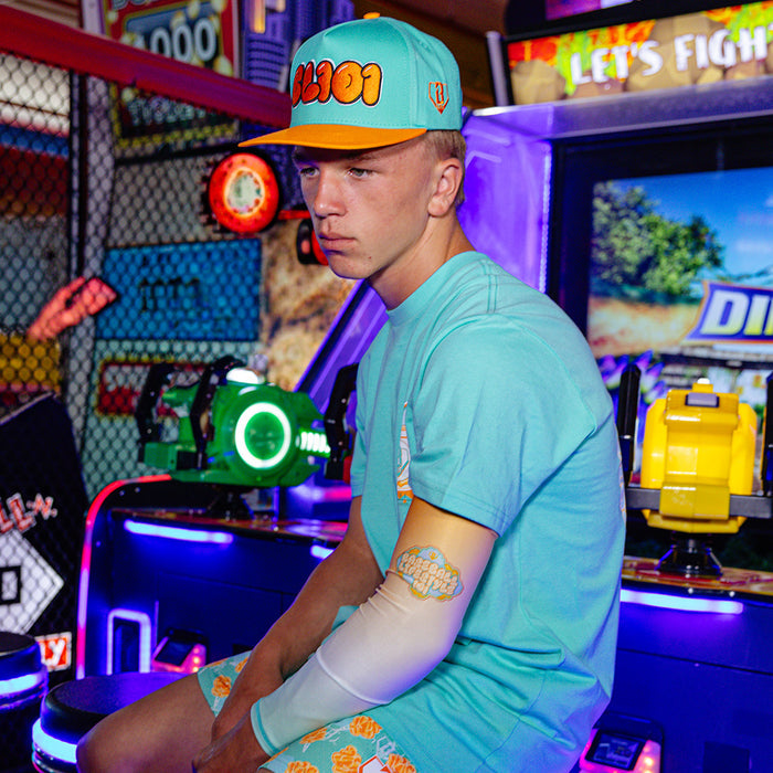 Youth model wearing Cotton Candy Tangerine Freeze youth arm sleeve