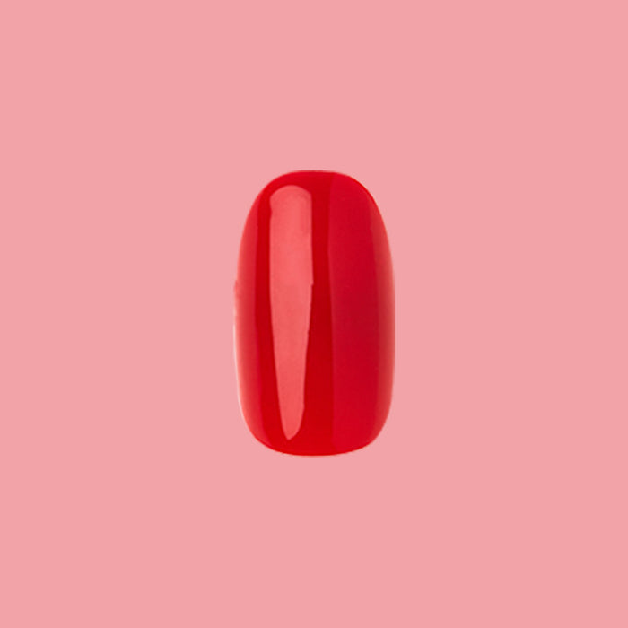 CV - Press-On | Short | Round showing single bright cherry red short round press-on nail on pink background