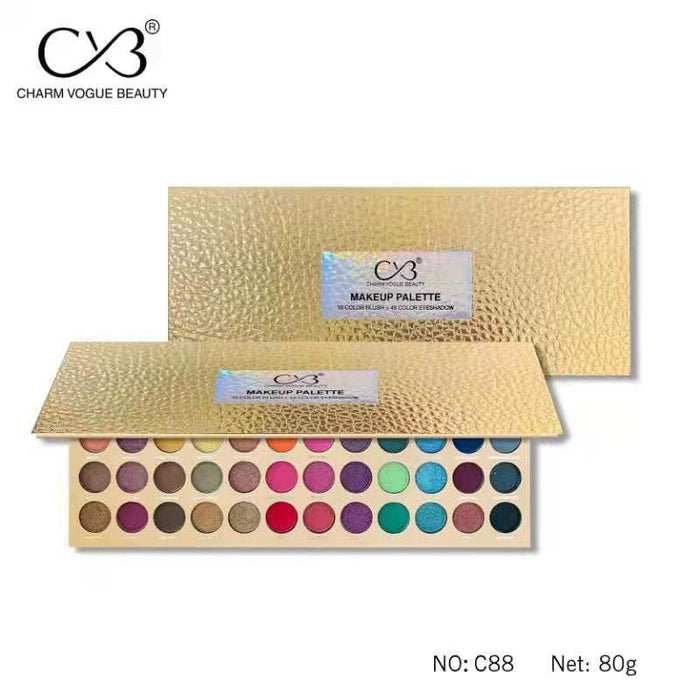 Makeup palette with gold packaging and visible color swatches on a white background