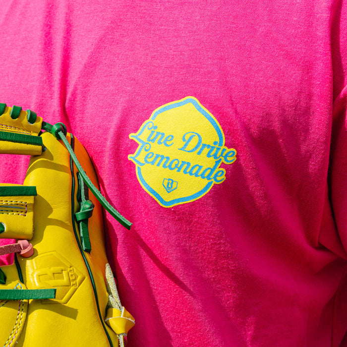Adult model wearing pink graphic tee with "Electric Lemonade" design
