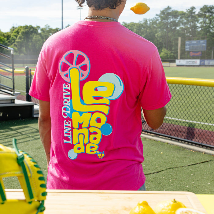 Adult model wearing pink graphic tee with "Electric Lemonade" design