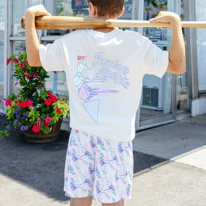 Youth model wearing youth shorts with "Fastball Scoops" design