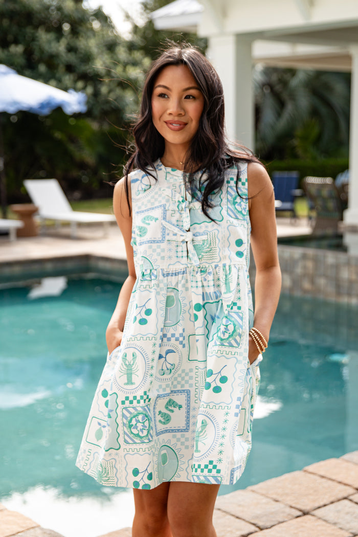 Woman wearing a patterned dress by a poolside