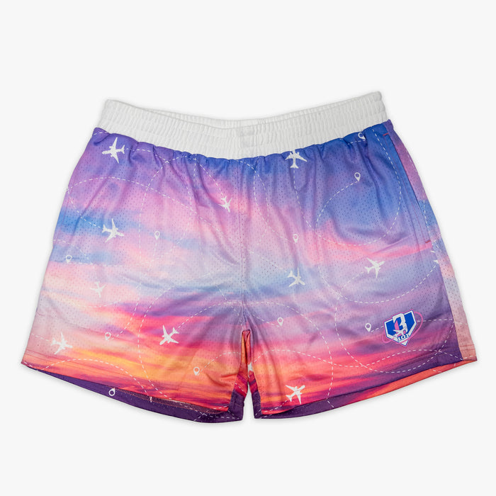 Youth model wearing multi-color Flight Map Sunrise youth shorts