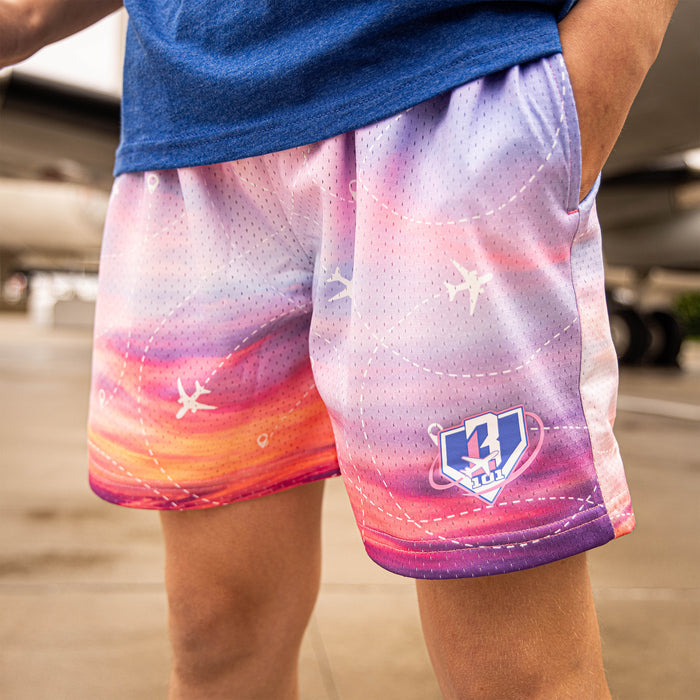 Youth model wearing multi-color Flight Map Sunrise youth shorts