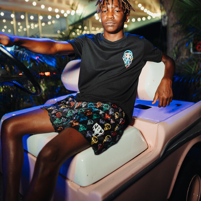 Youth model wearing black Ice Cream Scoops youth shorts