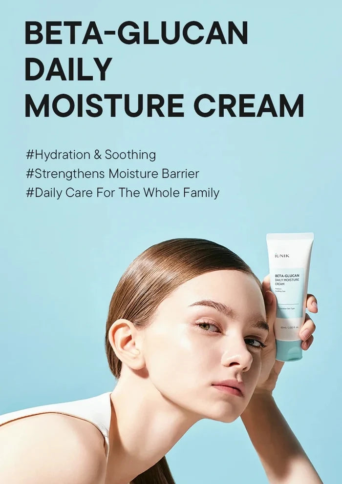 Woman holding a tube of Beta-Glucan daily moisture cream against a light blue background