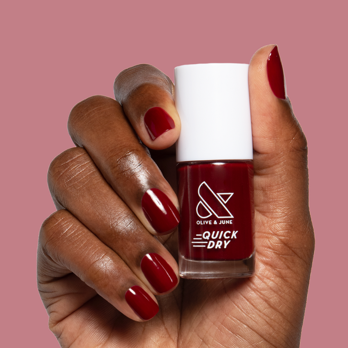 Jammy quick dry gel polish shown on natural nails with matching bottle against mauve background