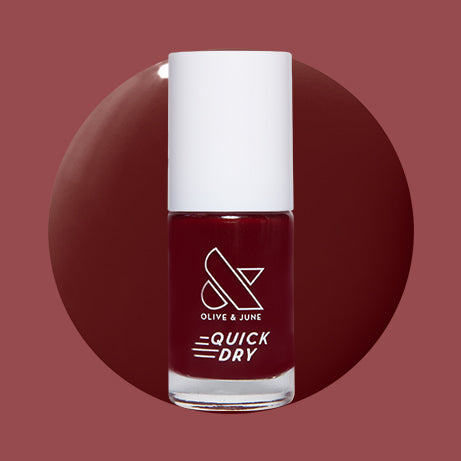 Jammy quick dry gel polish bottle in deep cabernet shade on round color swatch with muted background