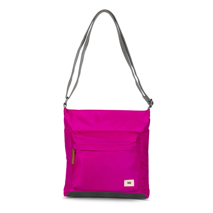 Sustainable nylon crossbody bag in bright magenta with zip front pocket