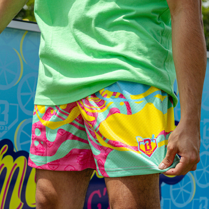 Adult model wearing multi-color shorts with "Lemon Burst" design