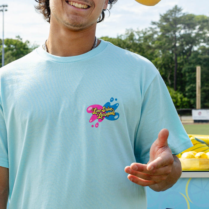 Adult model wearing blue graphic tee with "Lemon Burst" design