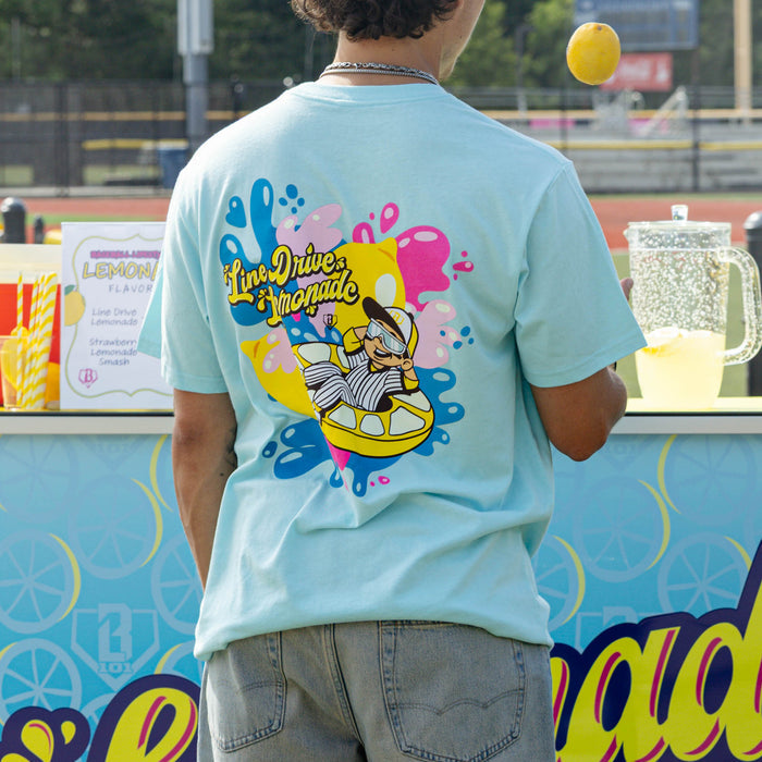 Adult model wearing blue graphic tee with "Lemon Burst" design