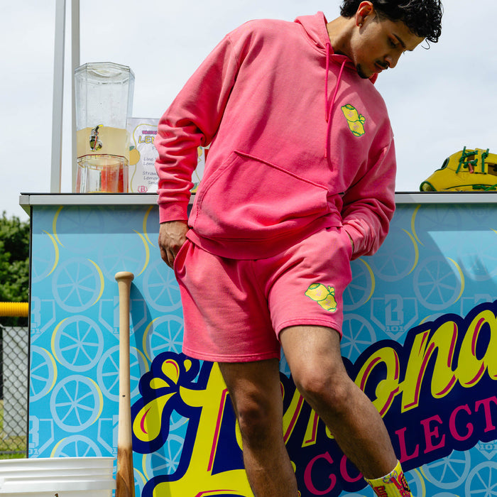 Adult model wearing pink shorts with "Lemon Dingers" design