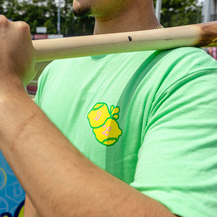 Adult model wearing green graphic tee with "Lemon Dingers" design