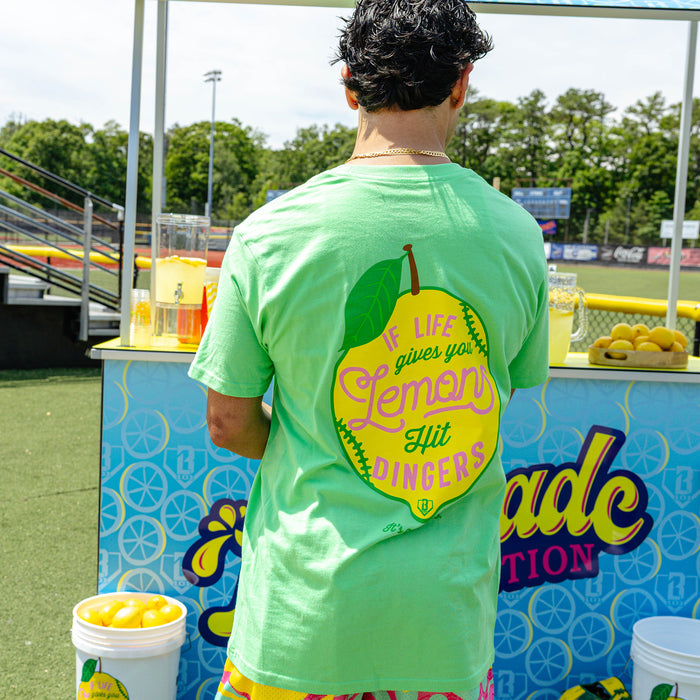 Adult model wearing green graphic tee with "Lemon Dingers" design