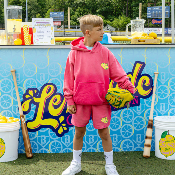 Youth model wearing pink youth shorts with "Lemon Dingers" design