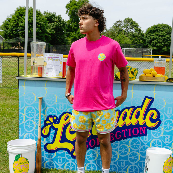 Adult model wearing blue shorts with "Lemon Squeeze Court" design