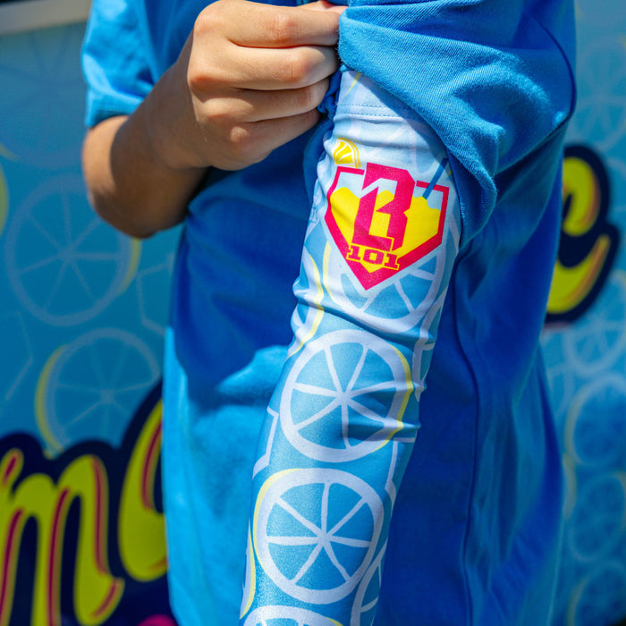Adult model wearing blue arm sleeve with "Lemonade Splash" design