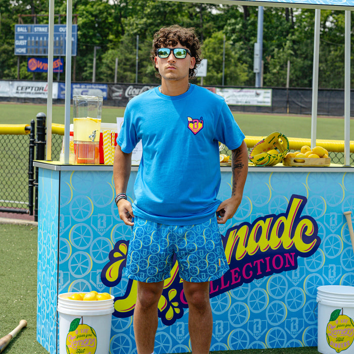 Adult model wearing blue shorts with "Lemonade Splash" design