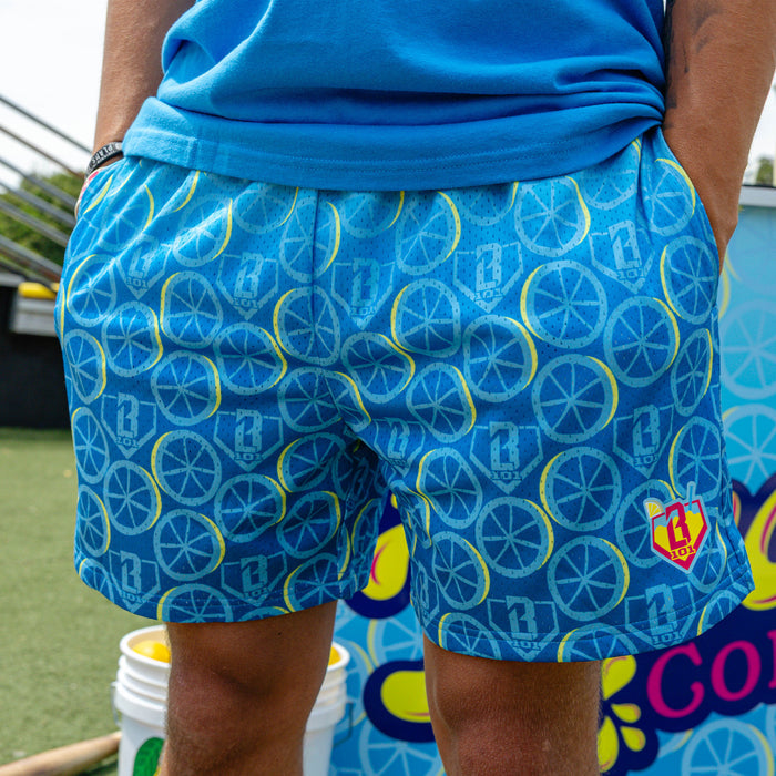 Adult model wearing blue shorts with "Lemonade Splash" design