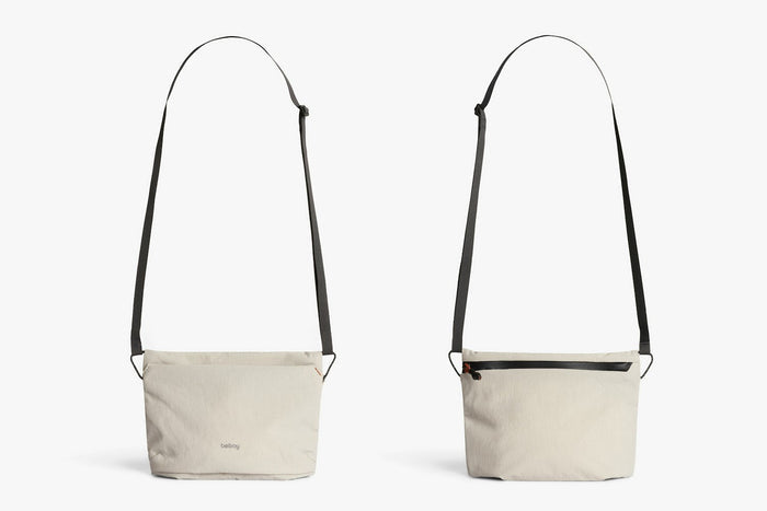 Light ash crossbody bag with black webbing handles and zip-top, front and back views