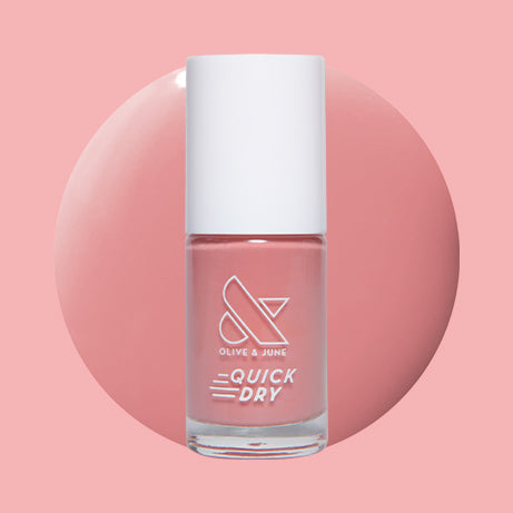 Lovely dusty rose quick dry gel polish bottle on round color swatch with soft pink background