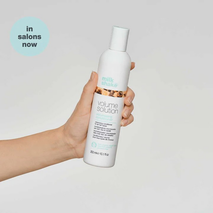 Milk_Shake Volumizing Conditioner model holding bottle