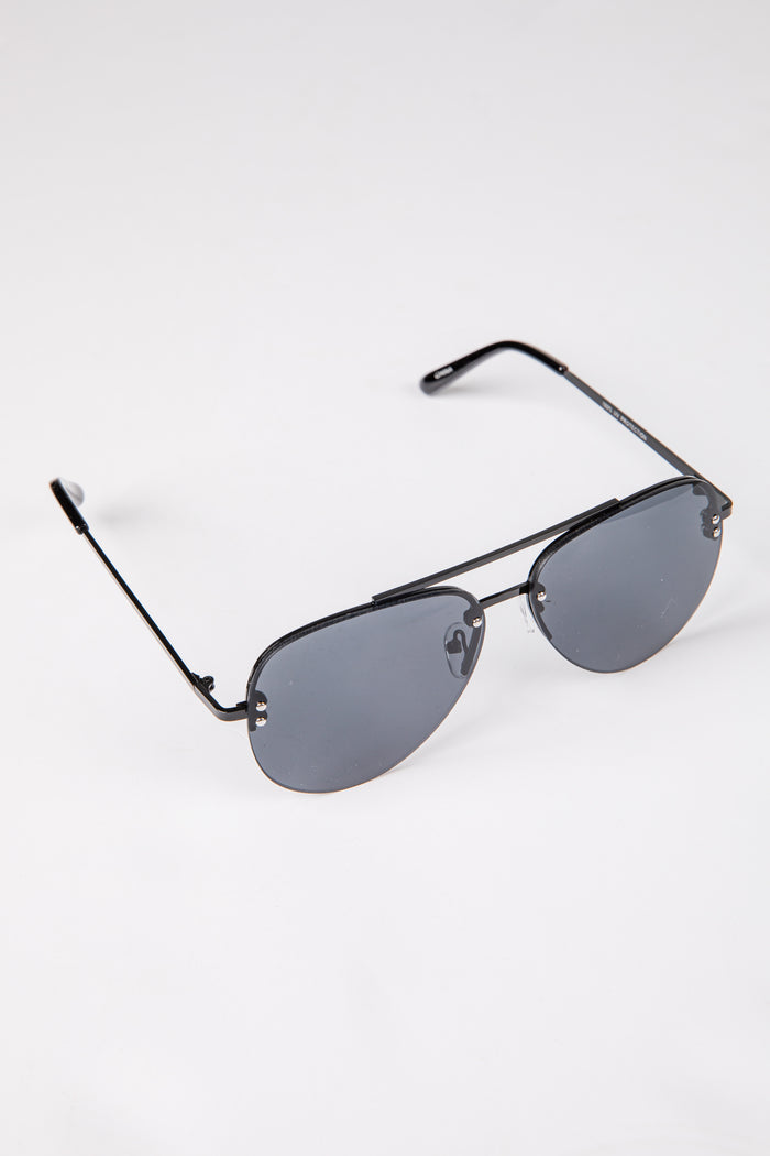 Aviator sunglasses with black frame and dark lenses on a white background