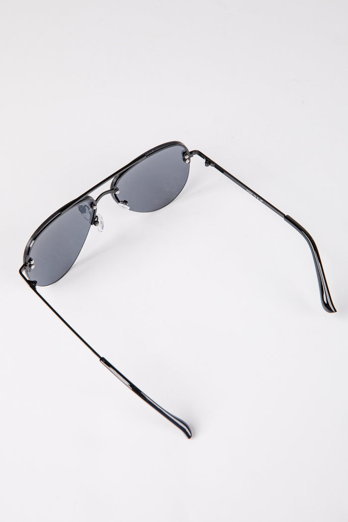 Sunglasses with black frames and reflective lenses on a white background